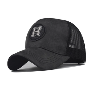 Detail of black mesh trucker hat featuring vintage 3D embroidered H letter logo on front