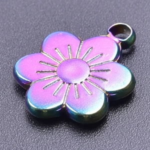 Macro view of rainbow plated stainless steel flower pendant with detailed engravings