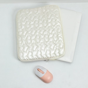 Quilted heart pattern laptop sleeve in cream white with soft padded texture and mouse
