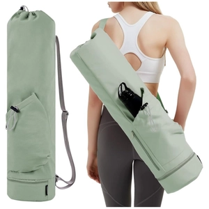 Detail of light green yoga mat bag featuring a side water bottle pocket and bottom wet compartment