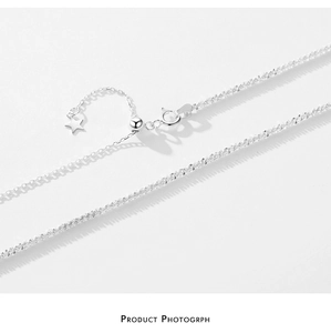 Detail of silver S925 sterling silver chain with adjustable star charm and spring clasp