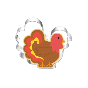 Detailed view of turkey-shaped stainless steel cookie cutter with decorated holiday biscuits