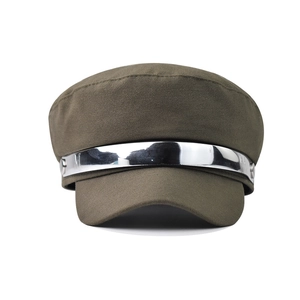 Detail of silver metallic band and rivets on an army green cadet cap with fabric texture