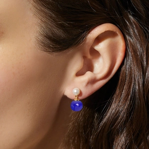 Close-up of S925 silver pearl and navy chalcedony drop earrings on a model's ear