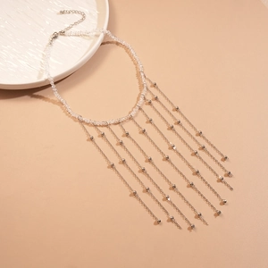 Detail of beaded necklace with cascading silver metal chains and faceted crystal beads