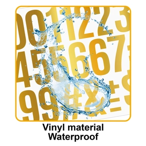 Close-up of waterproof gold vinyl stickers showing numbers and symbols under water splashes