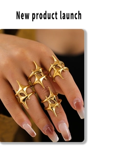 Detailed view of four piece set of 18k gold plated starburst rings on a model hand