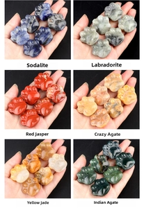 Detailed view of hand-carved natural gemstone cat paw charms in various crystal textures