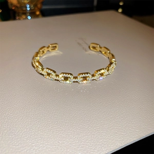 Macro shot of gold-plated chain link bracelet with pavé-set sparkling cubic zirconia