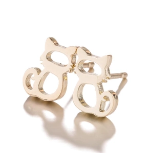 Detail of gold hollow cat stud earrings with smooth reflective metallic finish