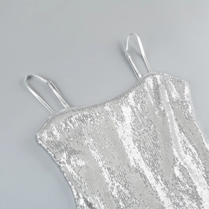 Macro detail of silver sequins and adjustable strap on a sparkling party dress