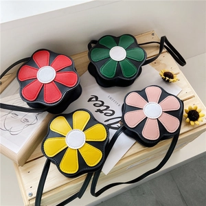 Top view of mini flower-shaped crossbody bags in red, green, yellow, and pink colors