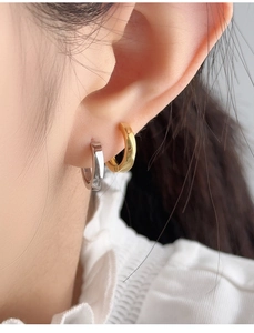 Detail view of gold and silver S925 sterling silver hoop earrings with a square edge design