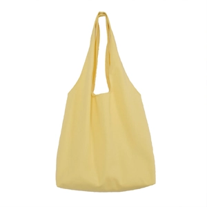 Minimalist large capacity solid light yellow canvas tote bag for women on white background
