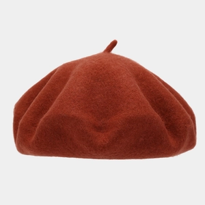 Close-up of a retro red-brown wool felt beret showing soft texture and top stem detail