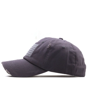Detail of distressed dark grey baseball cap with American flag patch and worn texture