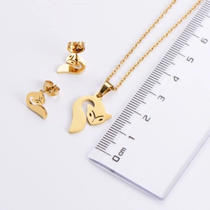 Detailed view of fox pendant necklace and earrings set with ruler measurement