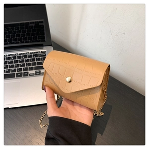Detail of khaki crocodile pattern PU leather small square bag with gold chain and clasp