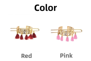Macro detail of hollow geometric hair pins with red and pink silk tassels in gold finish