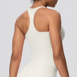 Detail view of the racerback design and elastic fabric on a cream sports bra