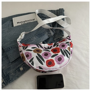 Detailed top-down view of large floral print dumpling bag with adjustable strap