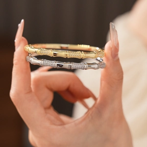 Macro detail of gold and silver bamboo style bracelets with micro-pave cubic zirconia