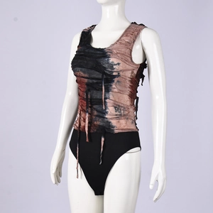 Close-up of grunge style tie-dye sleeveless top with distressed denim and torn fabric details