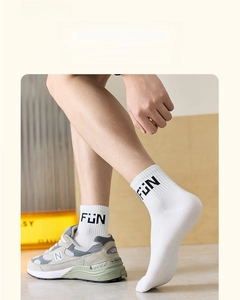 Close-up of white breathable cotton socks with 'FUN' lettering and premium mesh texture