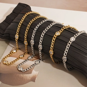 Gold and silver Cuban chain bracelets with round zircon on a premium display stand