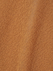 Nahaufnahme von orangefarbenem Strickstoff mit detaillierter Textur und Garnqualität