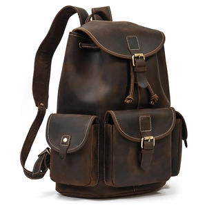 Detail of dark brown crazy horse leather backpack showing fine stitching and oily texture