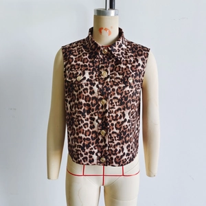 Detailed view of leopard print vest featuring gold buttons and flap chest pockets