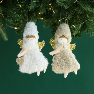 Two plush Christmas angel dolls with gold wings hanging on a festive tree branch