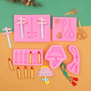 Macro view of pink silicone molds for fondant showing scissors and umbrella shapes