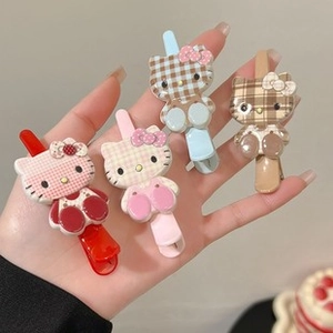 Set of four checkered Hello Kitty hair clips in red, pink, blue, and coffee colors