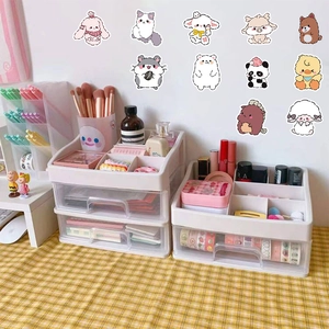 White desktop storage boxes shown on a yellow checkered cloth with cute animal stickers