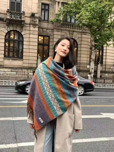 Close-up of thick ethnic style striped scarf with fringe detail on a female model