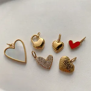 Detail of 14K gold stainless steel heart pendants with white shell and textured finishes