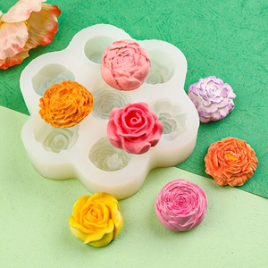 White silicone mold for 3D rose and peony candles with various colorful finished samples