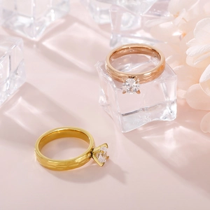 Macro shot of gold and rose gold zircon rings with hammered texture on clear ice