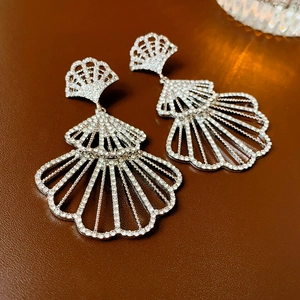 Sparkling silver fan-shaped drop earrings with pavé rhinestones on brown leather