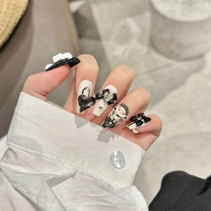 Handmade punk style press-on nails in black and white with 3D bows and heart charms