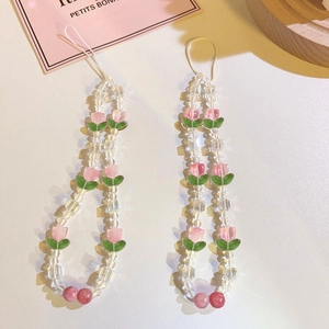 Detail view of pink tulip flower beads and transparent faceted crystals on phone charm