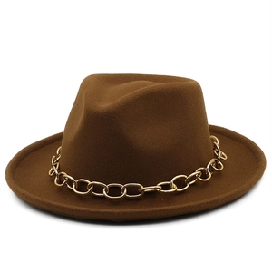 Detail of winter wool fedora hat featuring a chunky gold metal chain on brown felt