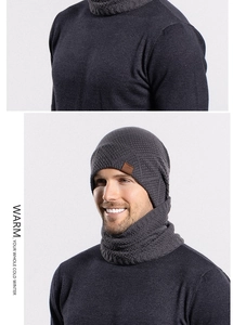 Detail of grey winter knit hat and neck warmer with ribbed texture and leather patch