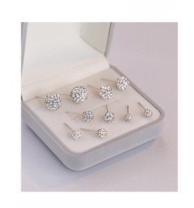 Macro detail of various sized S925 sterling silver ball stud earrings in a jewelry box