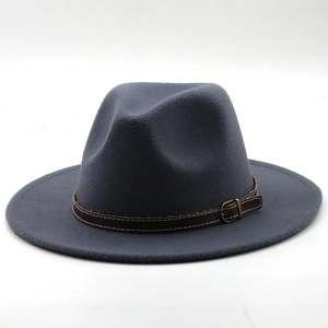 Detail of dark grey wool felt fedora hat featuring a brown leather band and gold buckle