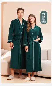Detail view of dark green couple's waffle bathrobe with white trim and waist belt detail