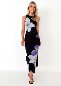 Detail of slim sleeveless black dress featuring purple and white floral digital printing