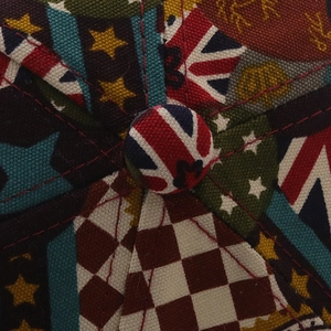 Detailed macro view of vintage flag and patchwork patterns on a stylish baseball cap